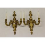 Pair of 19th Century carved and gilded composition twin light wall sconces of faceted baluster form,