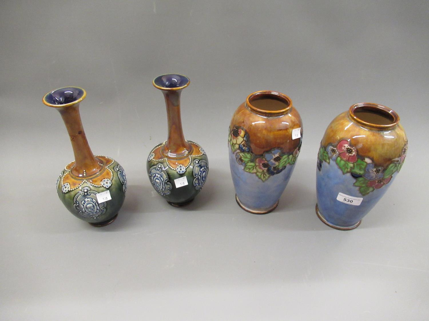 Pair of Royal Doulton baluster form stoneware vases with relief moulded floral decoration, 8.75ins