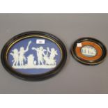 19th Century Wedgwood Jasperware oval wall plaque in white on a blue ground, depicting a group of