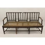 George III mahogany three seat chair back sofa, the narrow pierced splats above a cane seat on