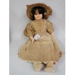 Wax shoulder plate doll with fixed brown eyes, wax limbs, wearing a lace dress and bonnet, 24ins