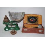 Pair of green painted kitchen scales with metal pan and set of weights together with a leather