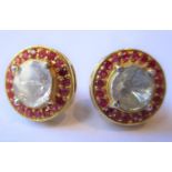 Pair of circular Indian yellow metal ear studs set large flat cut diamonds and a halo of rubies