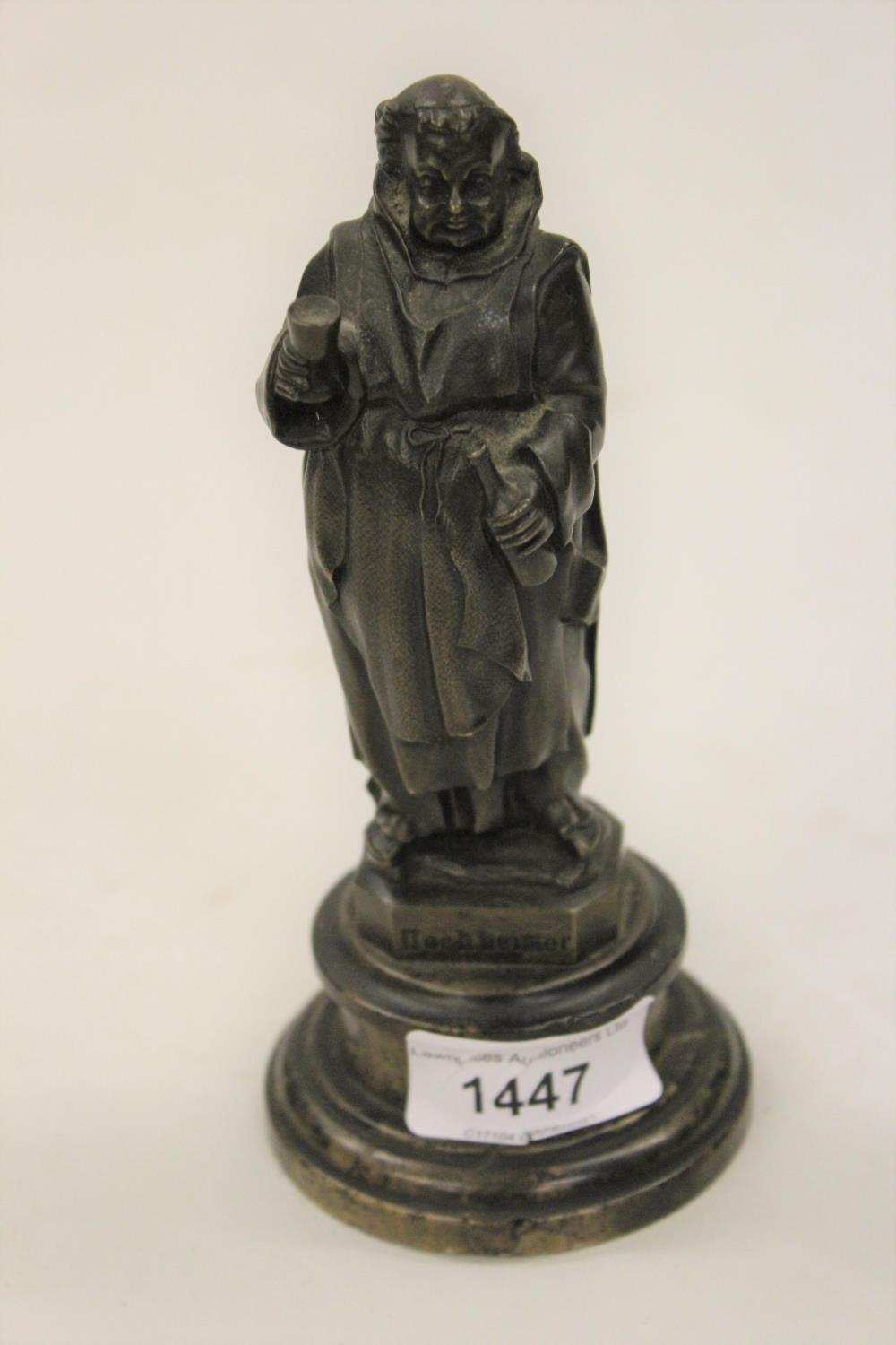 Small brown patinated bronze figure of a monk taking wine inscribed Hochheimer, mounted on a