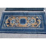 Group of four 20th Century small Chinese rugs and a small earlier prayer rug on red ground with