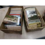 Two boxes containing a large quantity of mid 20th Century postcards