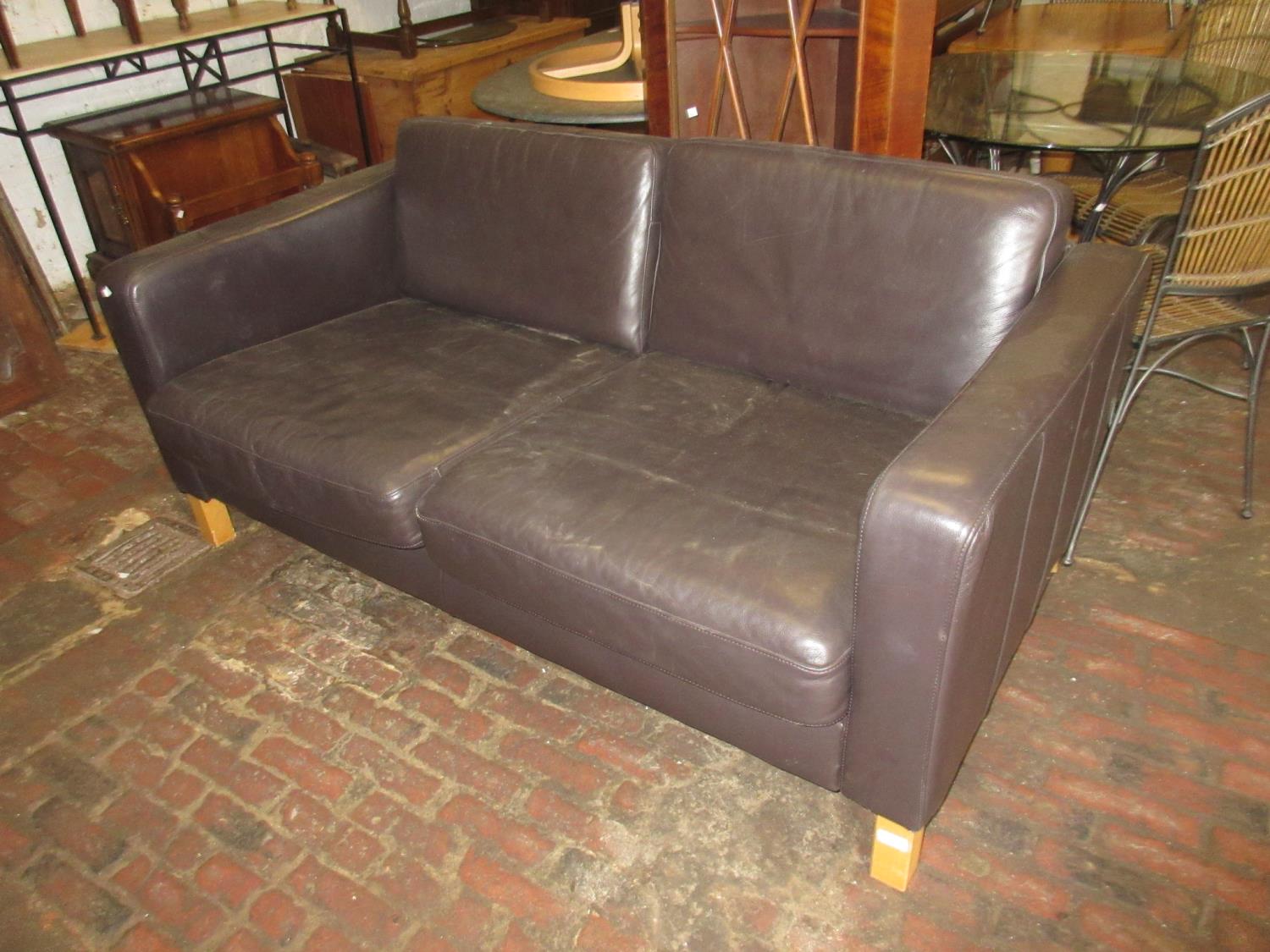 Modern brown leather upholstered two seat sofa on square beech supports, 65ins wide, 27ins high,