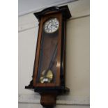 Vienna walnut and ebonised wall clock, the white enamel dial with Roman numerals and subsidiary