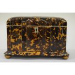 19th Century tortoiseshell serpentine shaped two division tea caddy, raised on low bun feet, 7.75ins