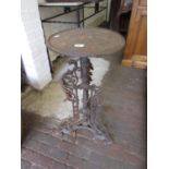 Low circular cast iron table on three shaped cast supports with tri-form base (at fault), 27ins