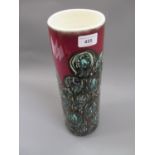 Mid 20th Century Poole pottery vase of cylindrical tapering form with stylised decoration on a red
