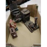 Group of three cast iron money banks in the forms of an artillery gun, Father Christmas and a