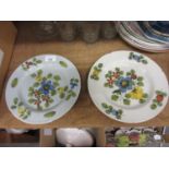 Pair of antique Delft ware plates with polychrome decoration in the form of flowers, 10ins