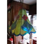 Pair of reproduction leaded and coloured glass hanging lamps of irregular octagonal tapering form in