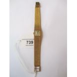 Ladies 9ct Gold wristwatch by Tissot with integral woven bracelet, silvered dial and baton numerals,