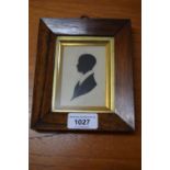 19th Century rosewood framed silhouette profile portrait of a boy, together with a miniature