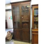 Early 19th Century mahogany bookcase, the reeded and moulded cornice above a pair of bar glazed