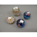 Group of four various glass paperweights including Ahus, Sweden