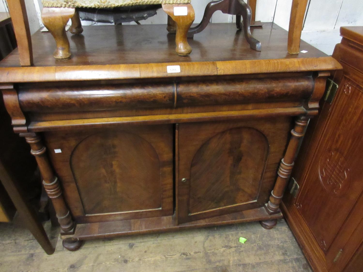 Victorian mahogany chiffonier, the deep moulded top above a concealed drawer, two arched panel doors