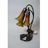 Reproduction Art Nouveau patinated metal and glass three light table lamp of floral design