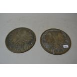 Pair of East European circular brass wall plaques decorated in relief with a spread eagle above