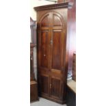 Mid 18th Century oak standing corner cabinet, the two pairs of fielded and crossbanded panel doors