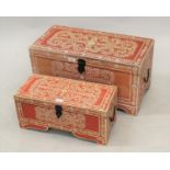 Two modern graduated storage boxes with hinged cover and floral decoration on a red ground, 12ins