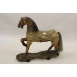 Carved wooden carousel horse adapted to a pull-a-long toy, with traces of original painted