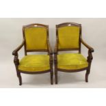 Pair of 19th Century French mahogany open arm chairs in Empire style, the backs and overstuffed