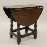 Charles II small oak drop leaf stool / table, circa 1680, the oval hinged top raised on turned
