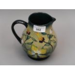 Modern Moorcroft baluster form pottery jug with tube lined floral decoration, 5.5ins high