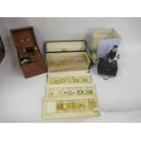 Student microscope together with a collection of microscope slides and a mahogany cased resistance
