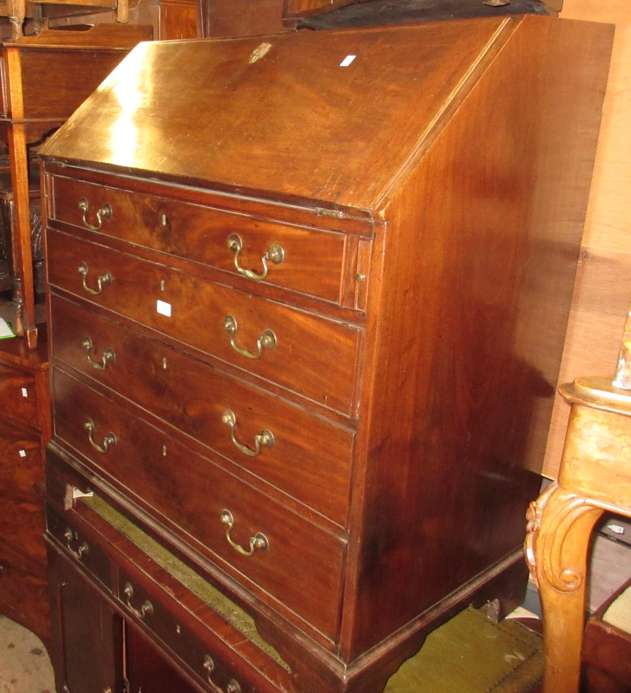 Early 19th Century mahogany bureau, the fall front enclosing a fitted interior above four