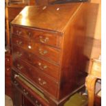 Early 19th Century mahogany bureau, the fall front enclosing a fitted interior above four