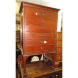 Early 20th Century mahogany six drawer music cabinet with blind fretwork decoration, 21ins wide