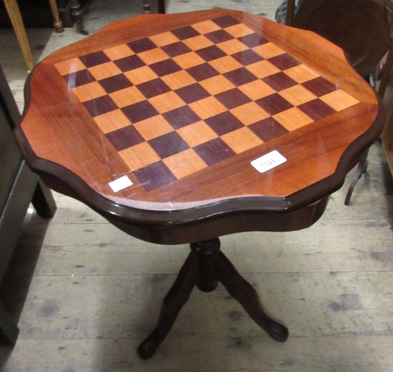 Reproduction circular mahogany games table, a mahogany three tier folding cake stand and a