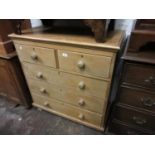 Mid 20th Century polished pine straight front chest of two short and three long drawers with knob