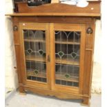 Arts and Crafts oak side cabinet, the shaped back above a pair of leaded glass doors enclosing