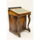 Victorian figured walnut Davenport, the hinged sloping lid with a green leather insert, the panelled