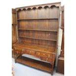 Early 19th Century oak dresser, the boarded shelf back above an arrangement of five drawers,
