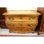 Antique Continental fruitwood bombe shaped commode chest, the moulded top above three long drawers