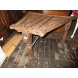 Far Eastern iron bound wooden occasional table of irregular shape, 34ins wide