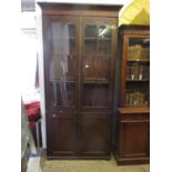 Early 19th Century mahogany bookcase, the reeded and moulded cornice above a pair of bar glazed