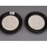 Pair of Royal Copenhagen bisque circular relief plaques decorated with classical scenes, 5ins