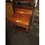 Reproduction mahogany Davenport in Victorian style with a rising top, hinged lid and carved cabriole