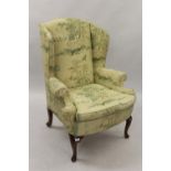 Upholstered wing armchair in 18th Century style, covered in an oriental style fabric of birds,