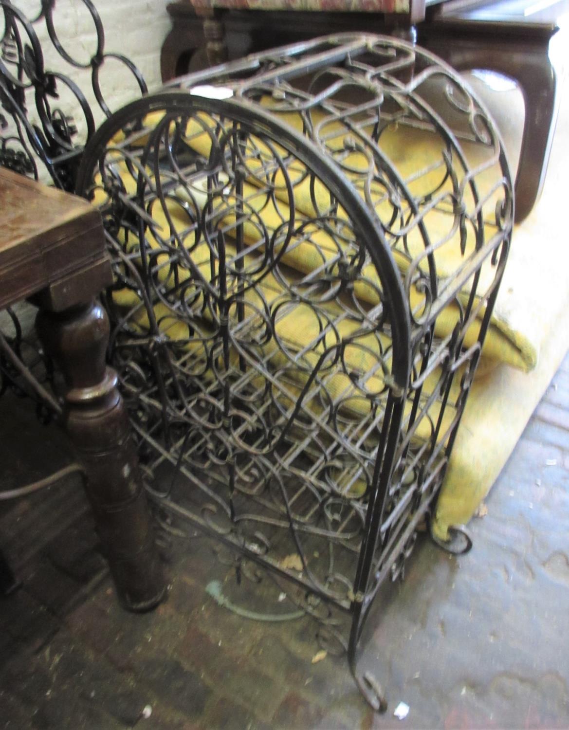 Mid to late 20th Century patinated wrought iron wine bottle cabinet of open work scroll design