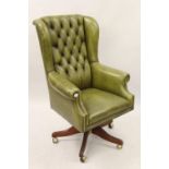 Late 20th Century green button leather upholstered office wing armchair, having five mahogany reeded