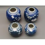 Group of four Chinese blue and white prunus blossom decorated ginger jars Hairline crack to one as