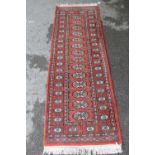Pakistan runner of Turkoman design, 6ft x 2ft approximately together with a similar smaller rug